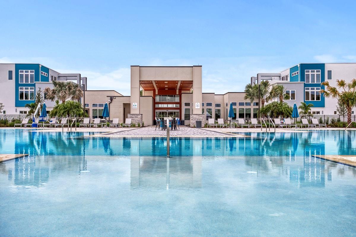 a view of swimming pool with outdoor seating and lake view