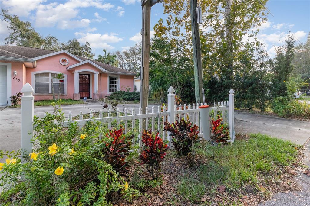 a front view of a house with a yard and fountain