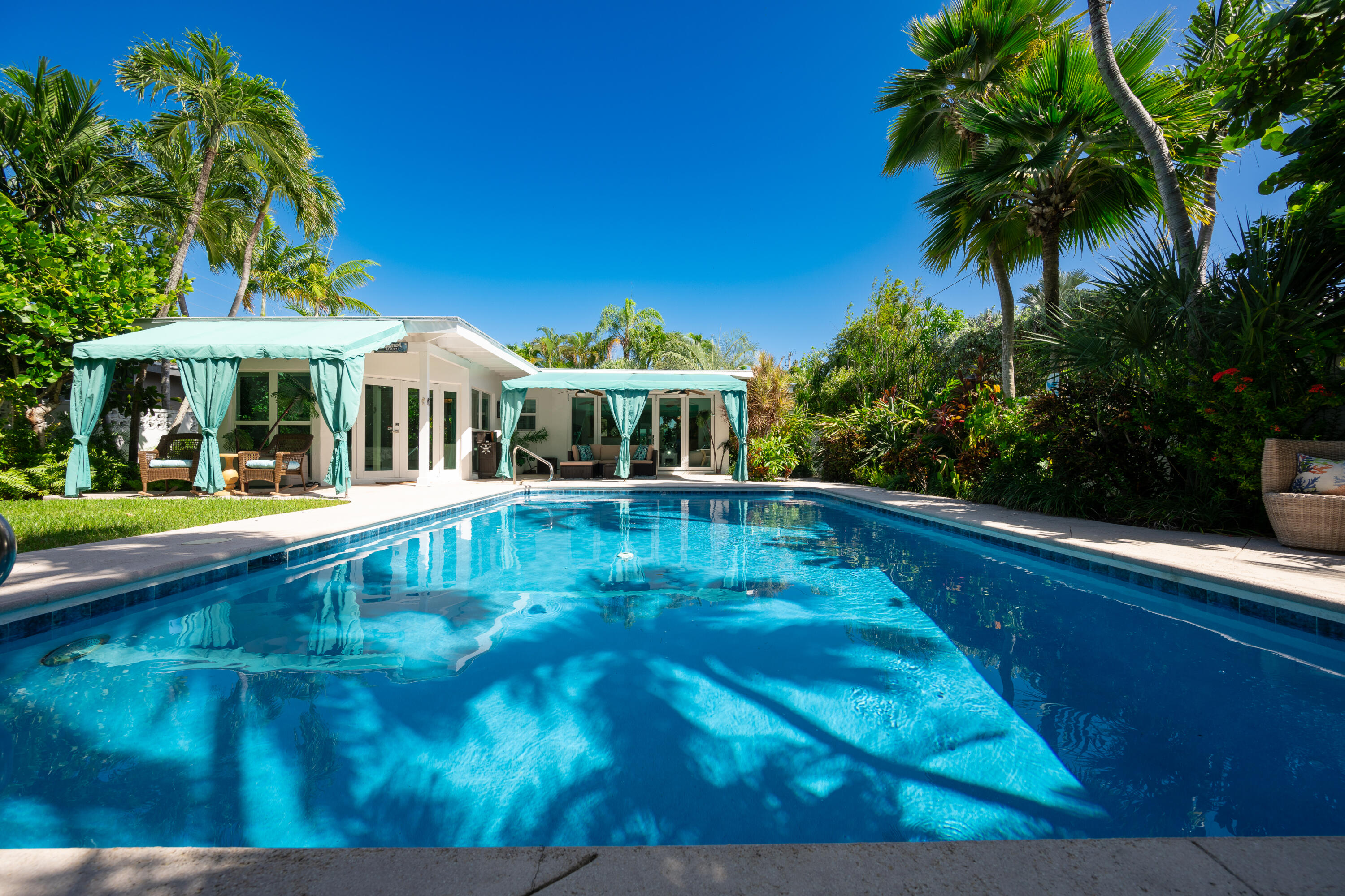 a view of an house with swimming pool and porch