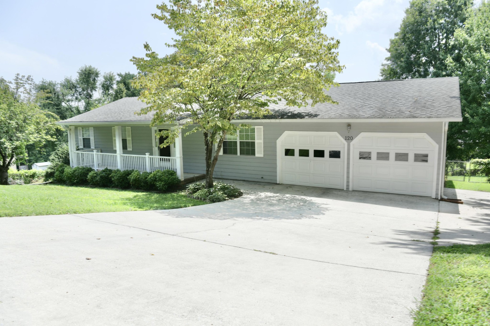 a front view of a house with a garden and garage