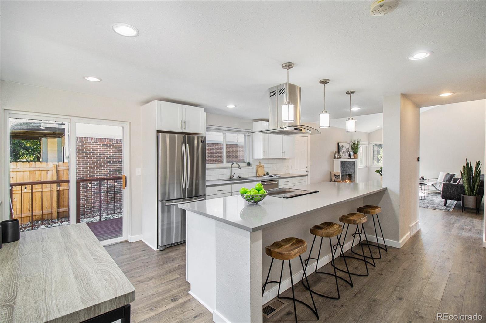 a kitchen with kitchen island wooden cabinets and refrigerator