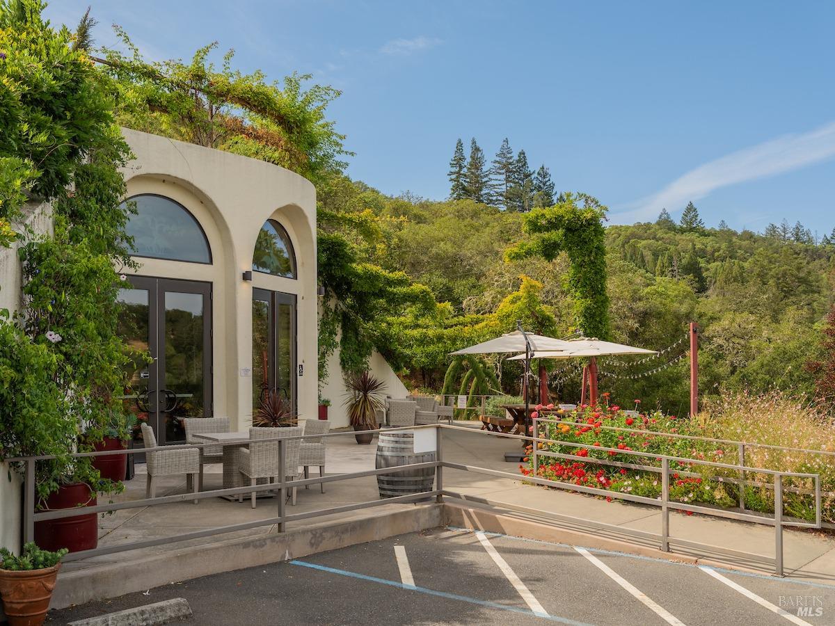 a view of a building with sitting area and garden