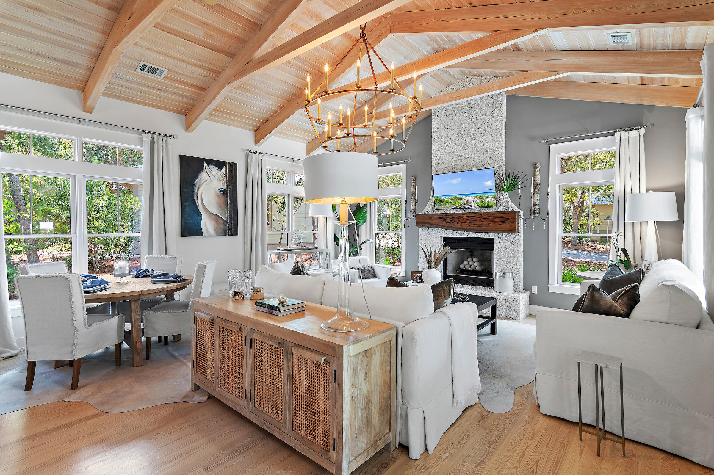 a living room with furniture a fireplace and a chandelier