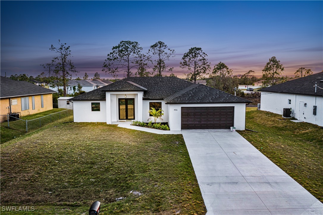 a front view of a house with garden