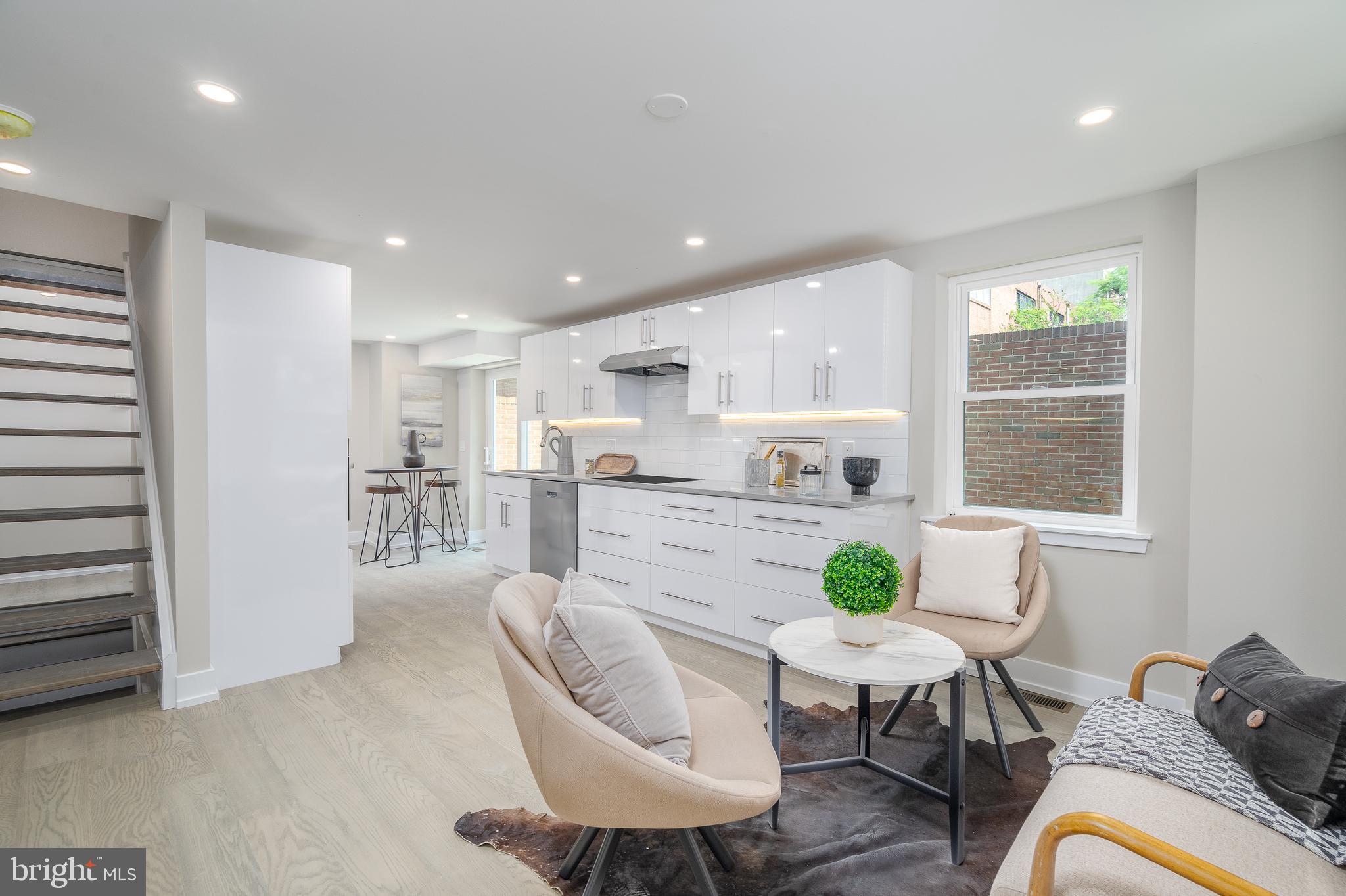 a living room with furniture kitchen and a table