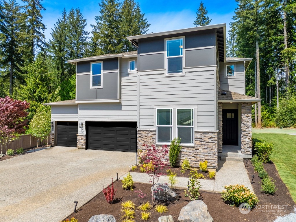 a front view of a house with a yard and garage