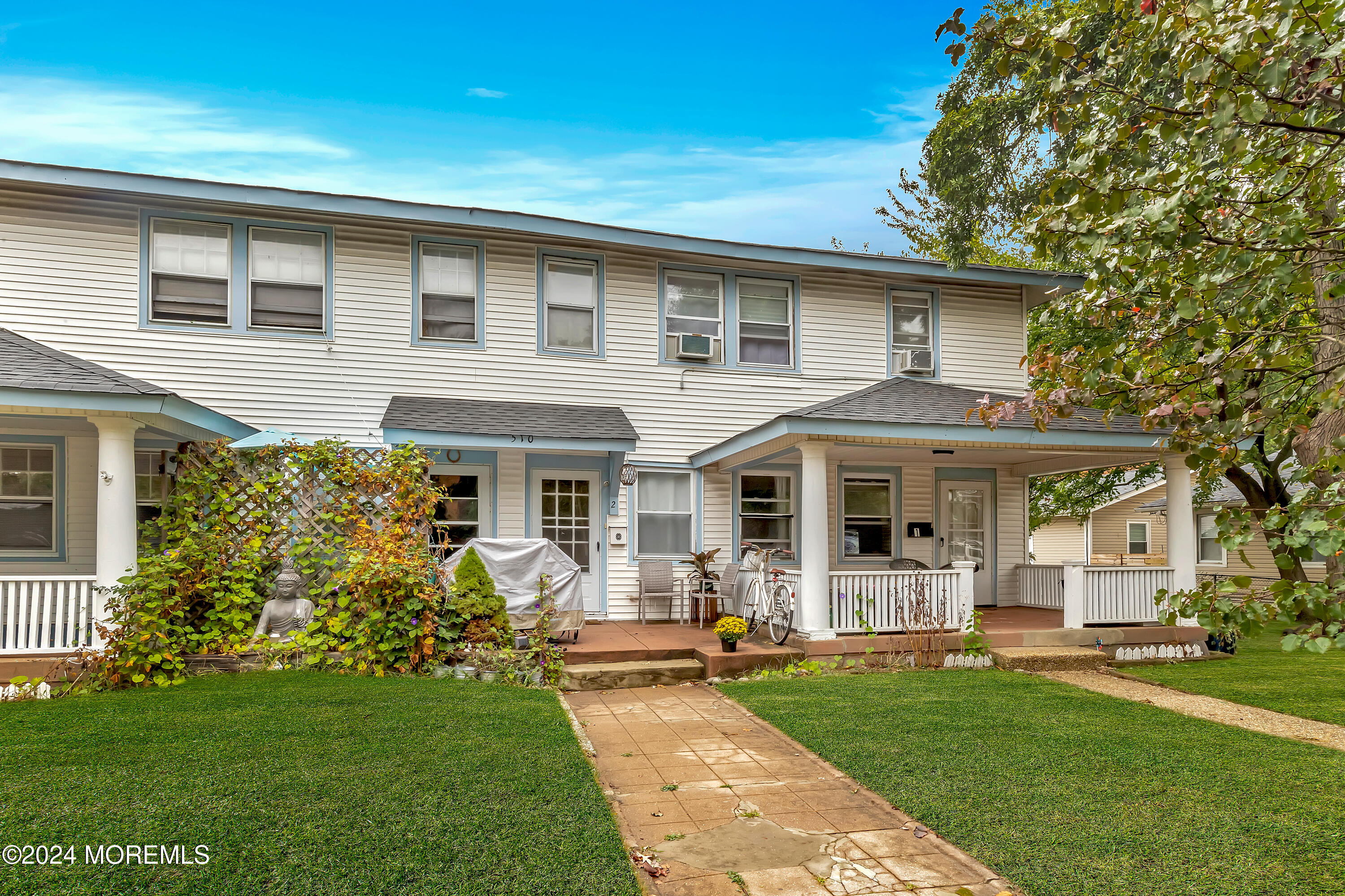 a front view of house with yard and green space