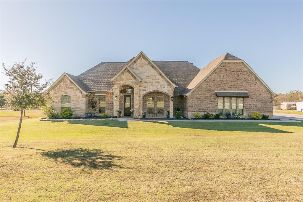 a front view of house with outdoor space and swimming pool