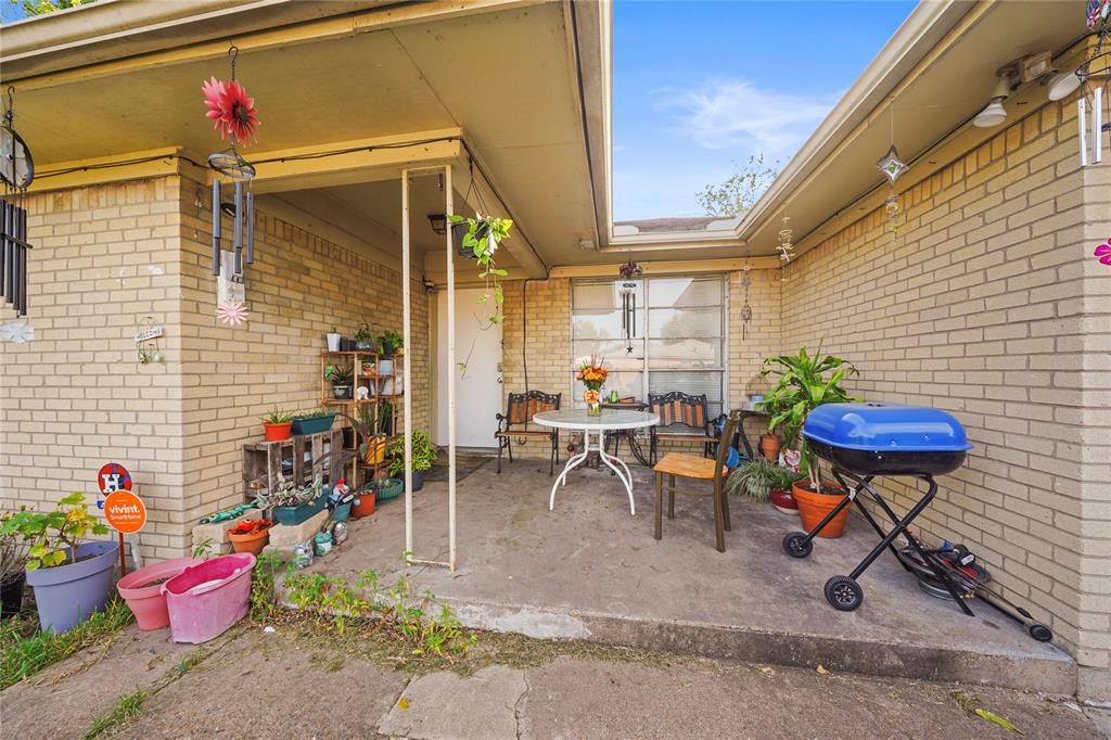 a backyard of a house with table and chairs