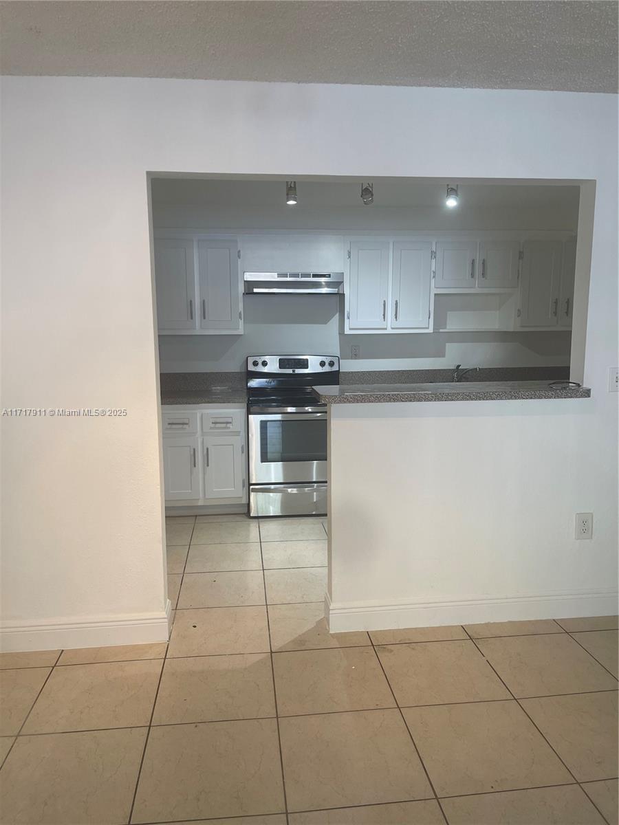 a kitchen with stainless steel appliances a stove a sink and a refrigerator