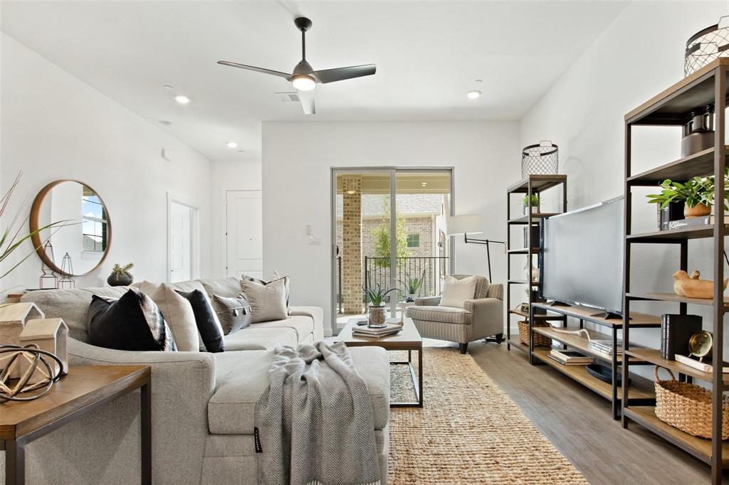 a living room with furniture a rug and white walls