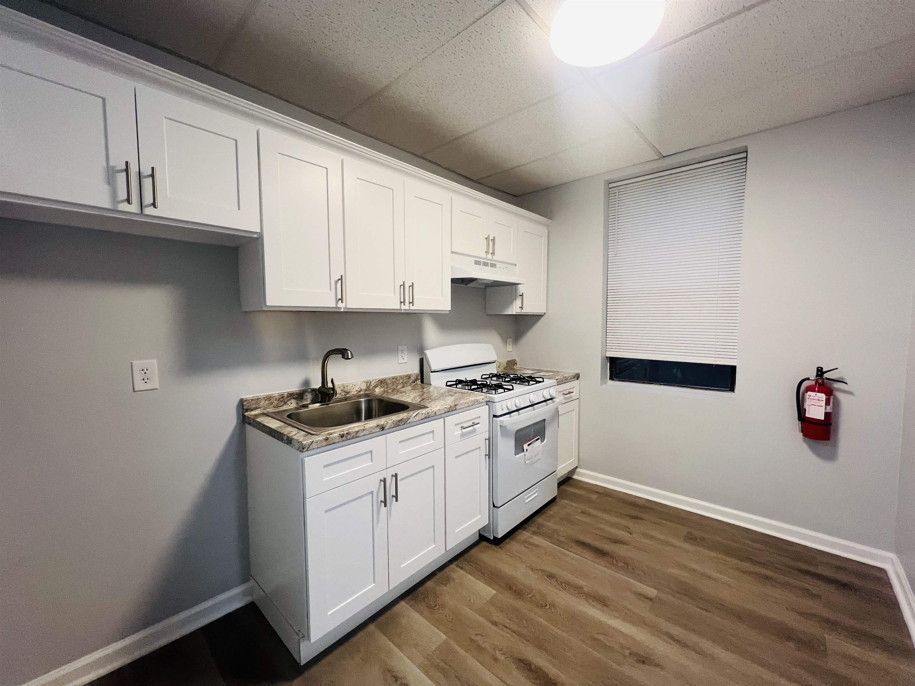 a kitchen with stainless steel appliances granite countertop a sink stove and cabinets