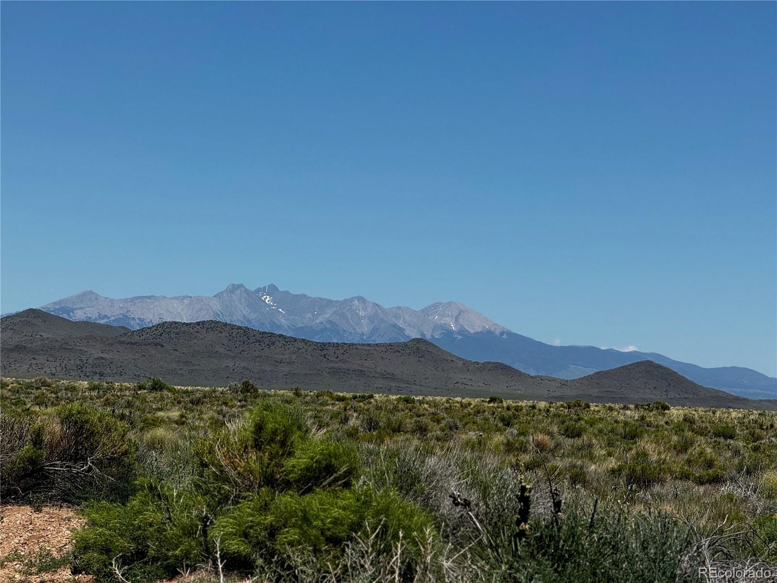 a view of a town with mountains in the background