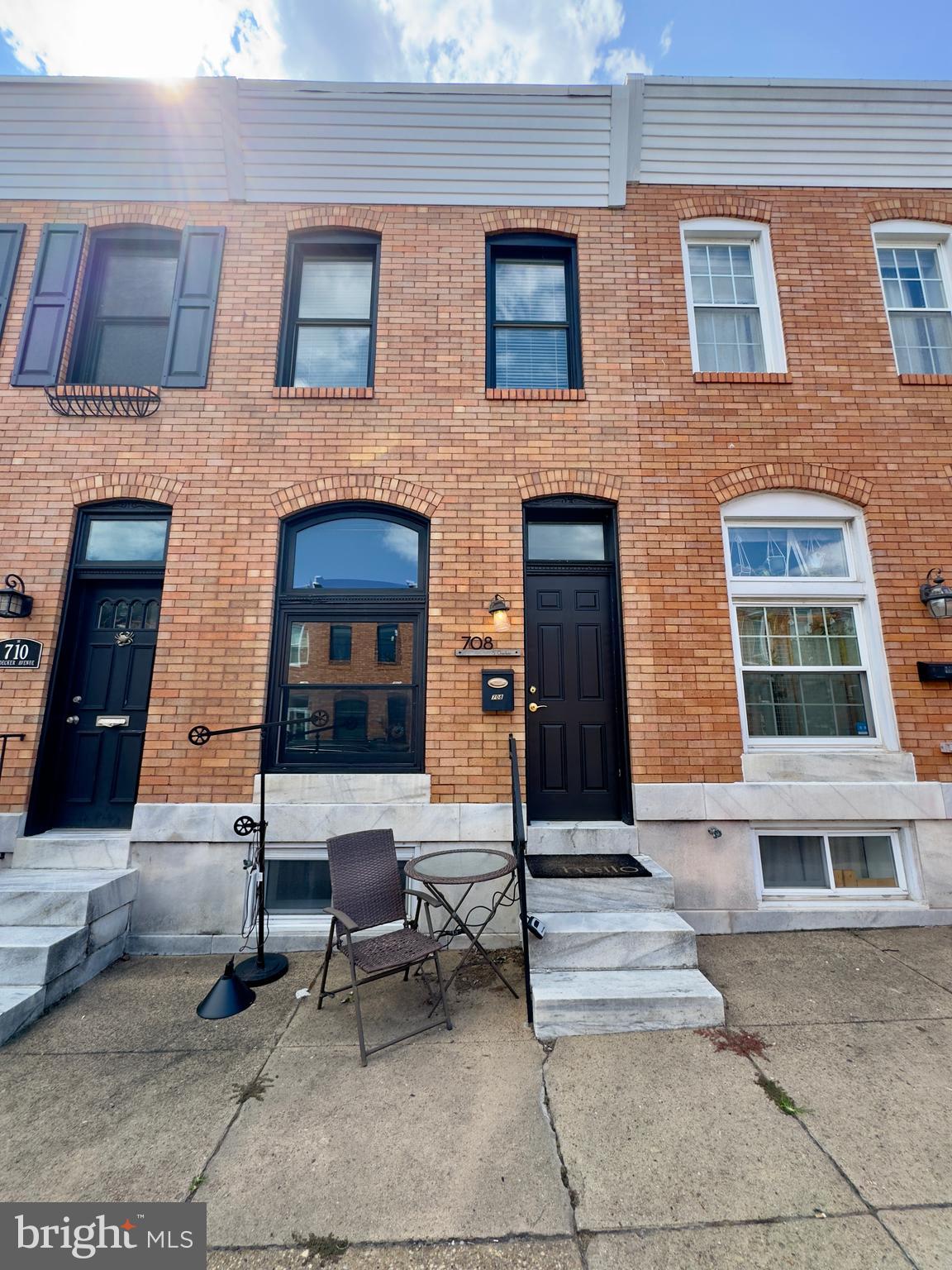 a building outdoor space with a couch and a fireplace