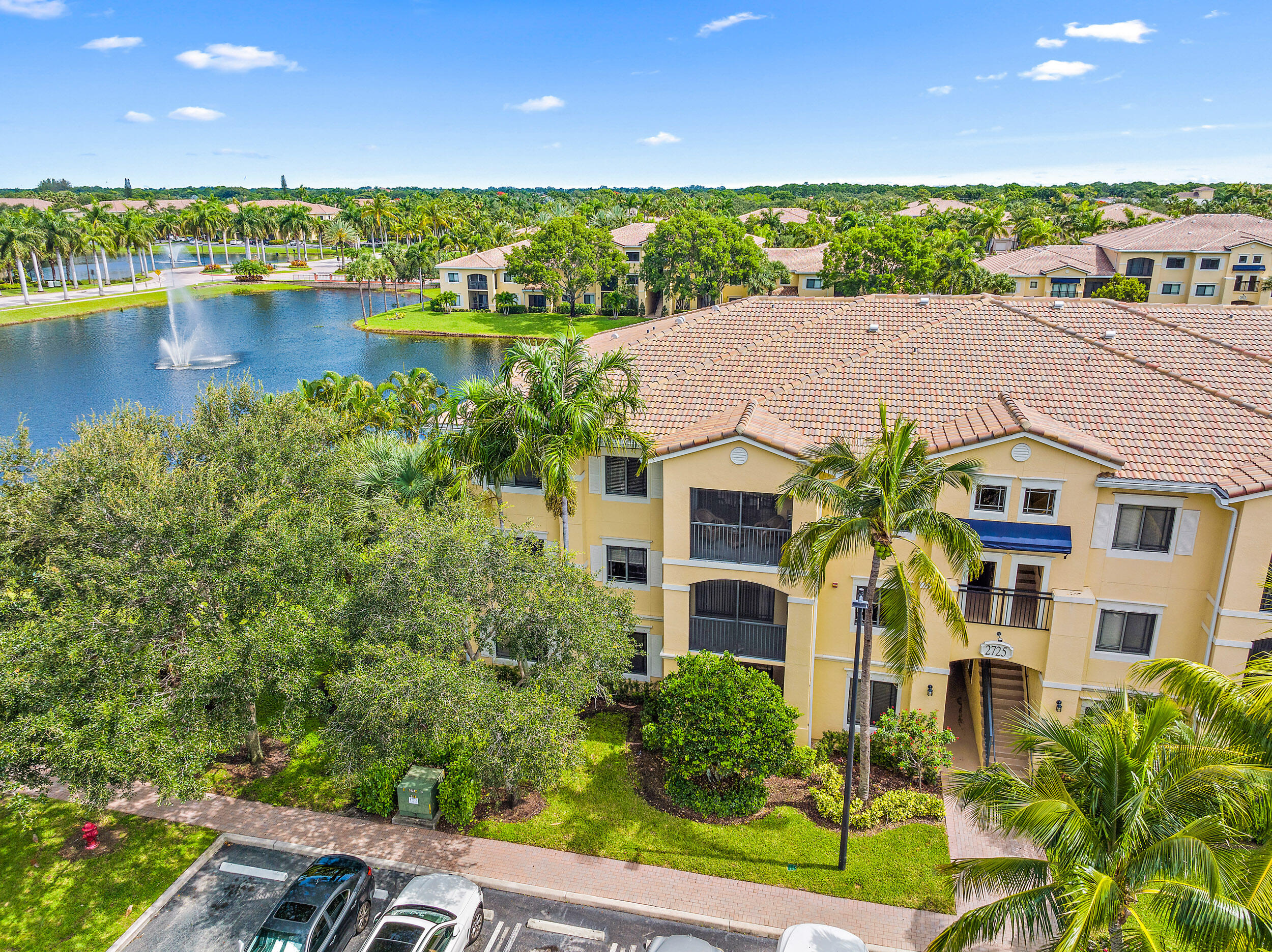 a aerial view of a house with pool and lake view