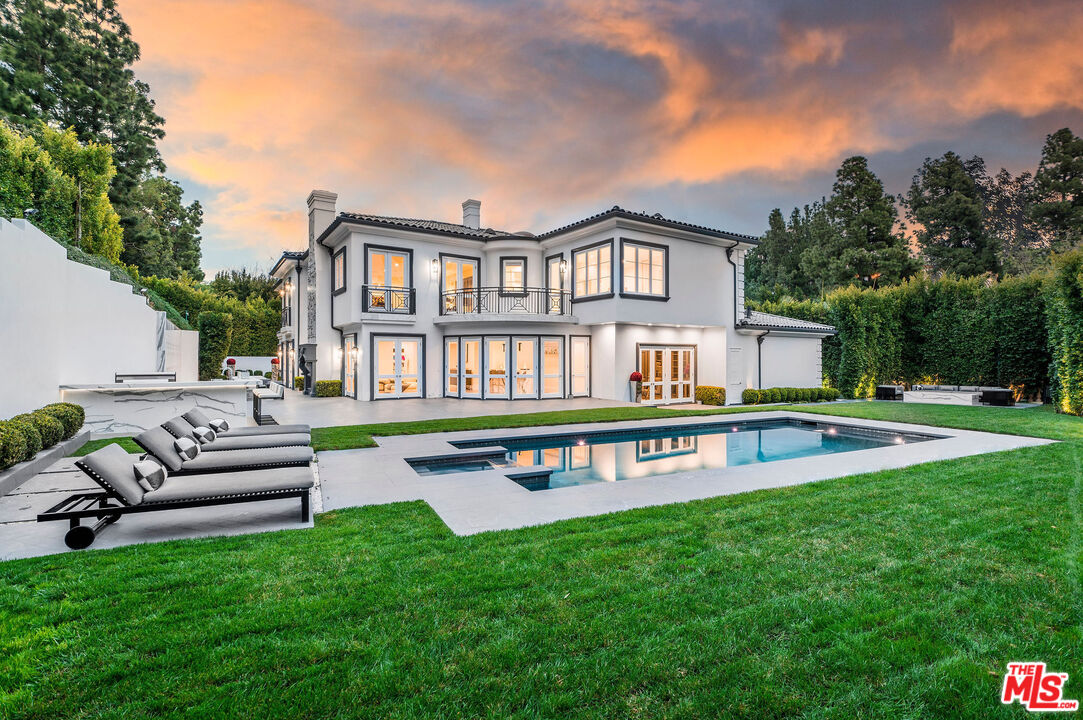 a view of an house with backyard and a patio