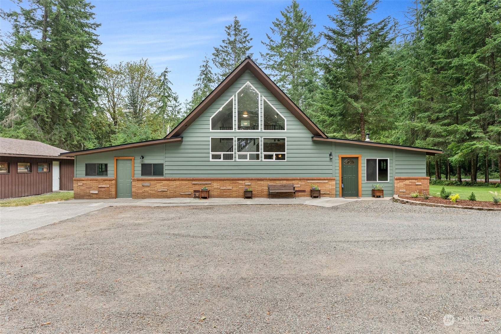 a front view of house with yard and trees