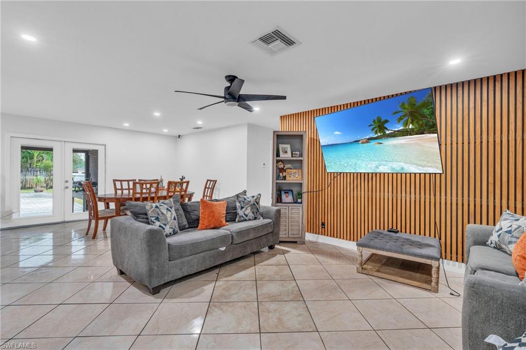 a living room with furniture and a ceiling fan