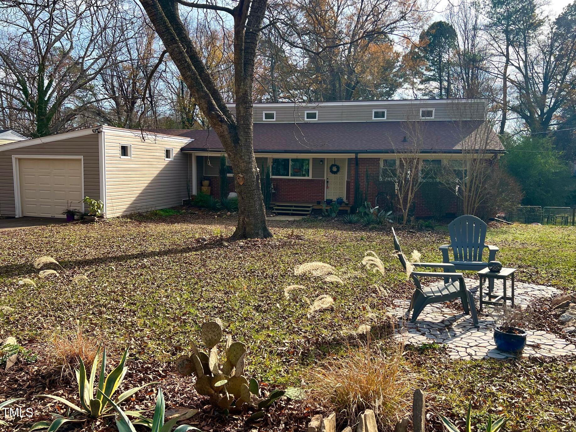 a view of a house with backyard porch and sitting area