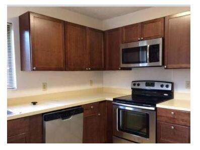 a kitchen with a sink stove and microwave