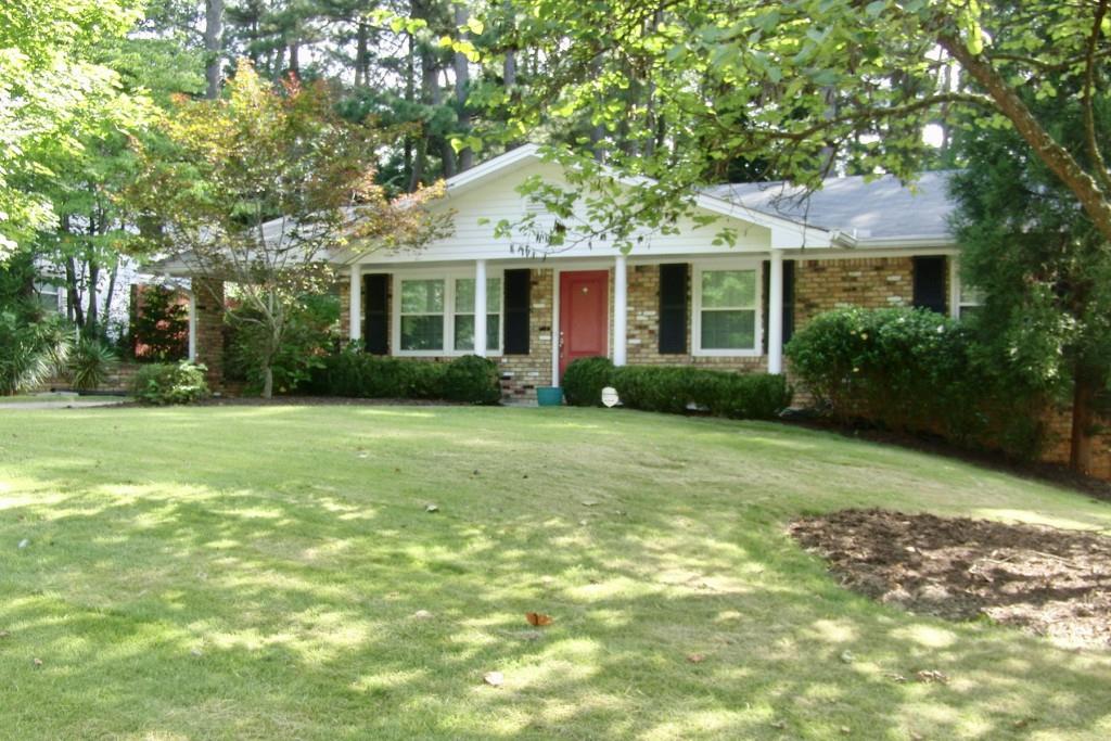 a front view of house with yard and green space