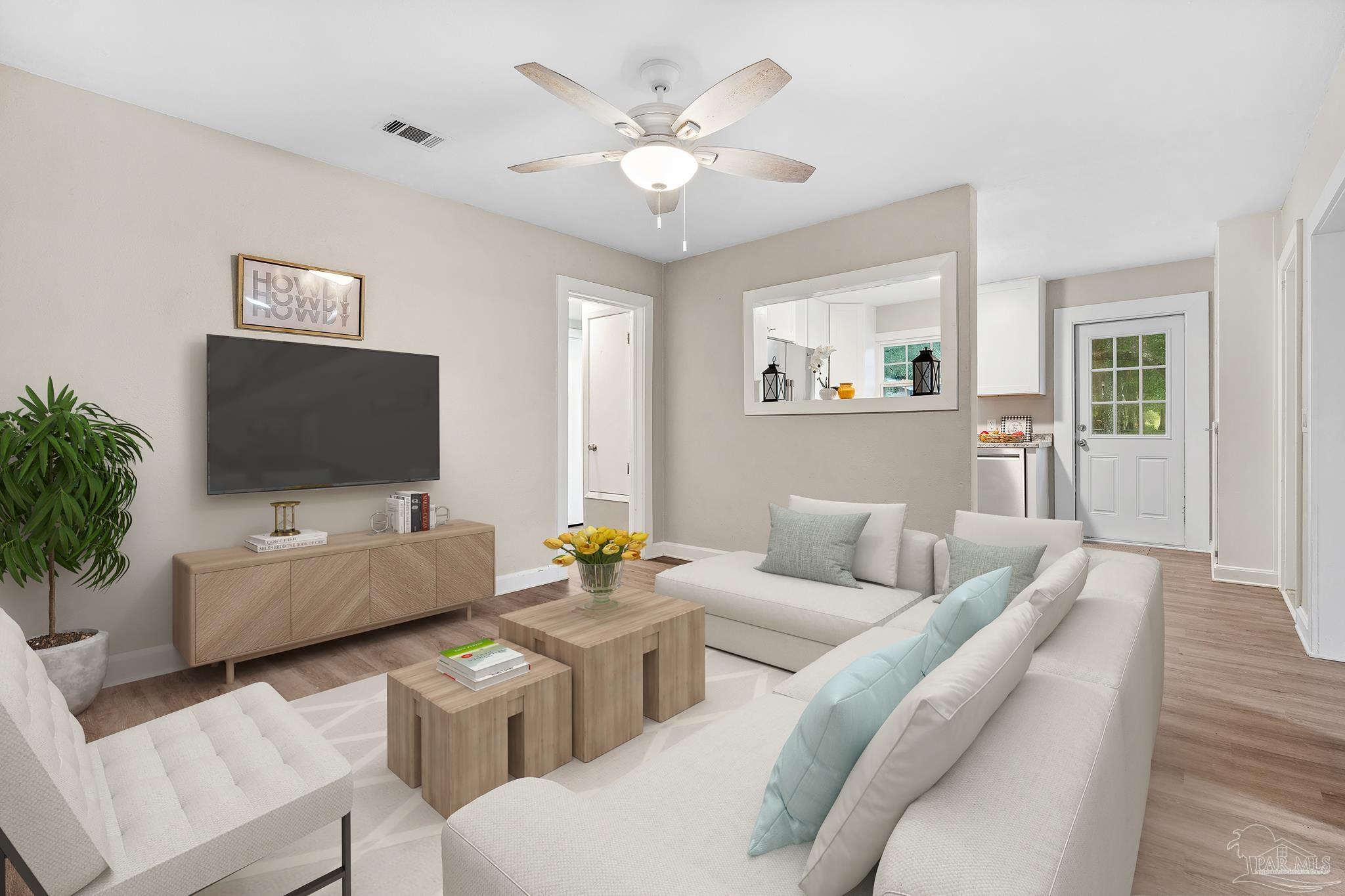 a living room with furniture and a flat screen tv