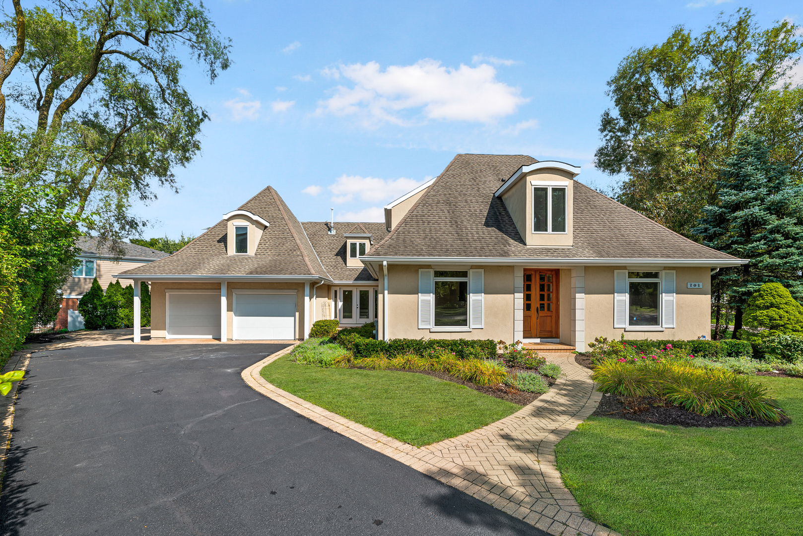 a front view of a house with a garden