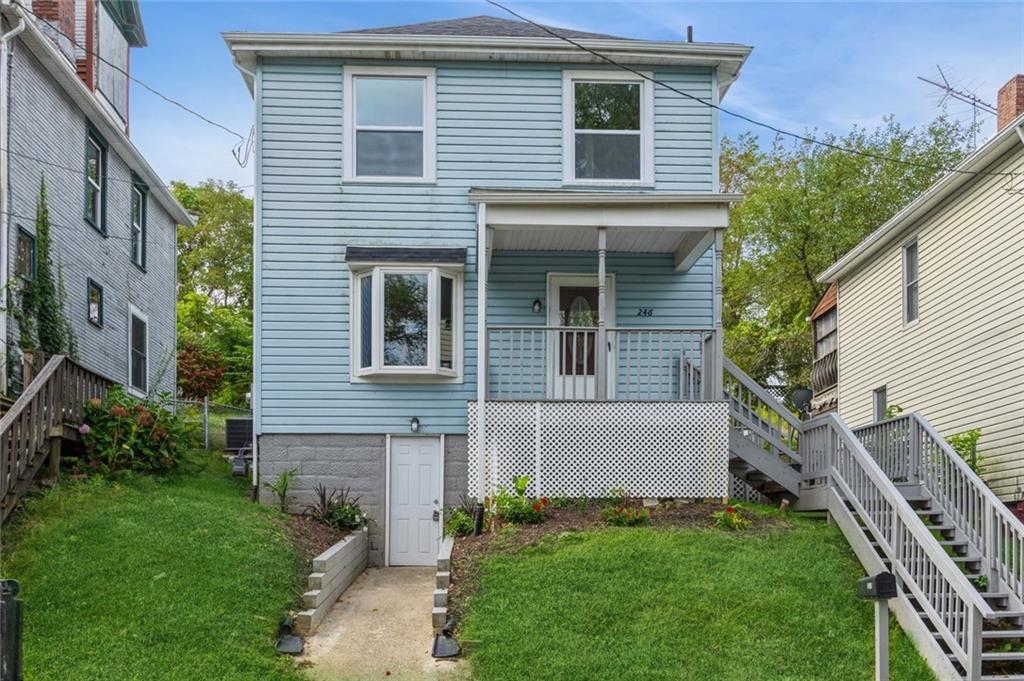 a view of house with a yard