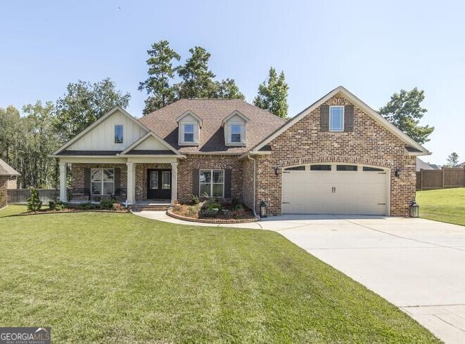 a front view of house with yard outdoor seating and barbeque oven