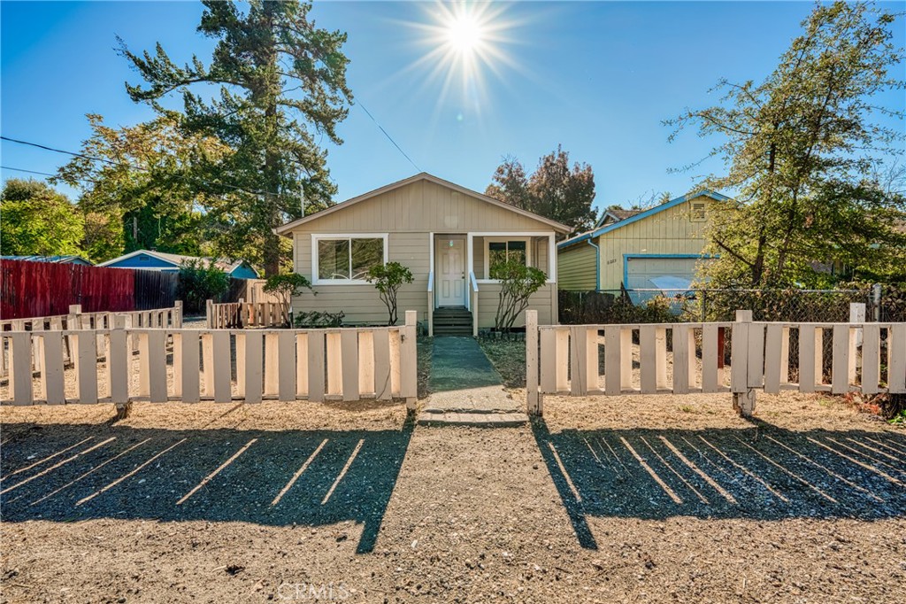 a view of a house with wooden fence