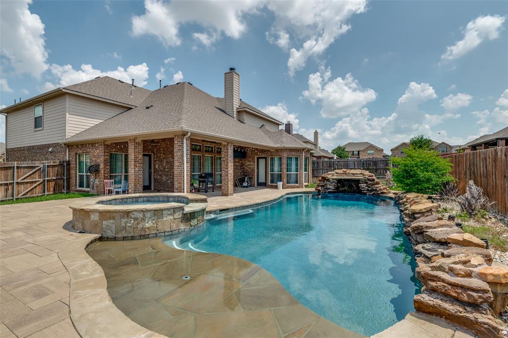 a view of a house with swimming pool and sitting area