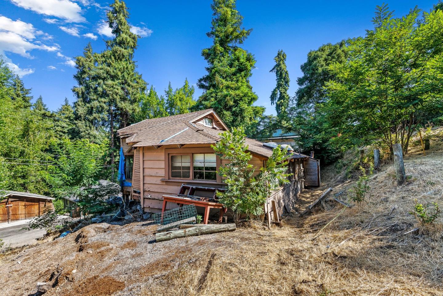 a small house with a tree in the background