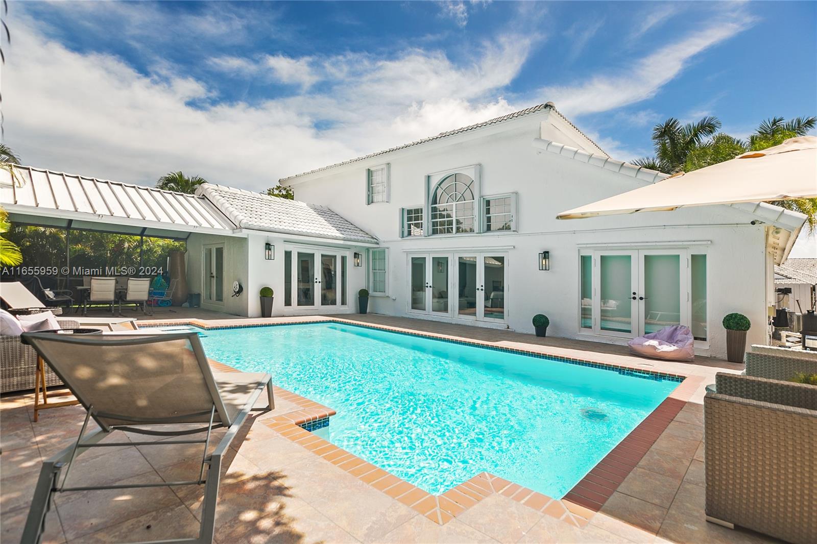 a view of a house with a yard patio and swimming pool