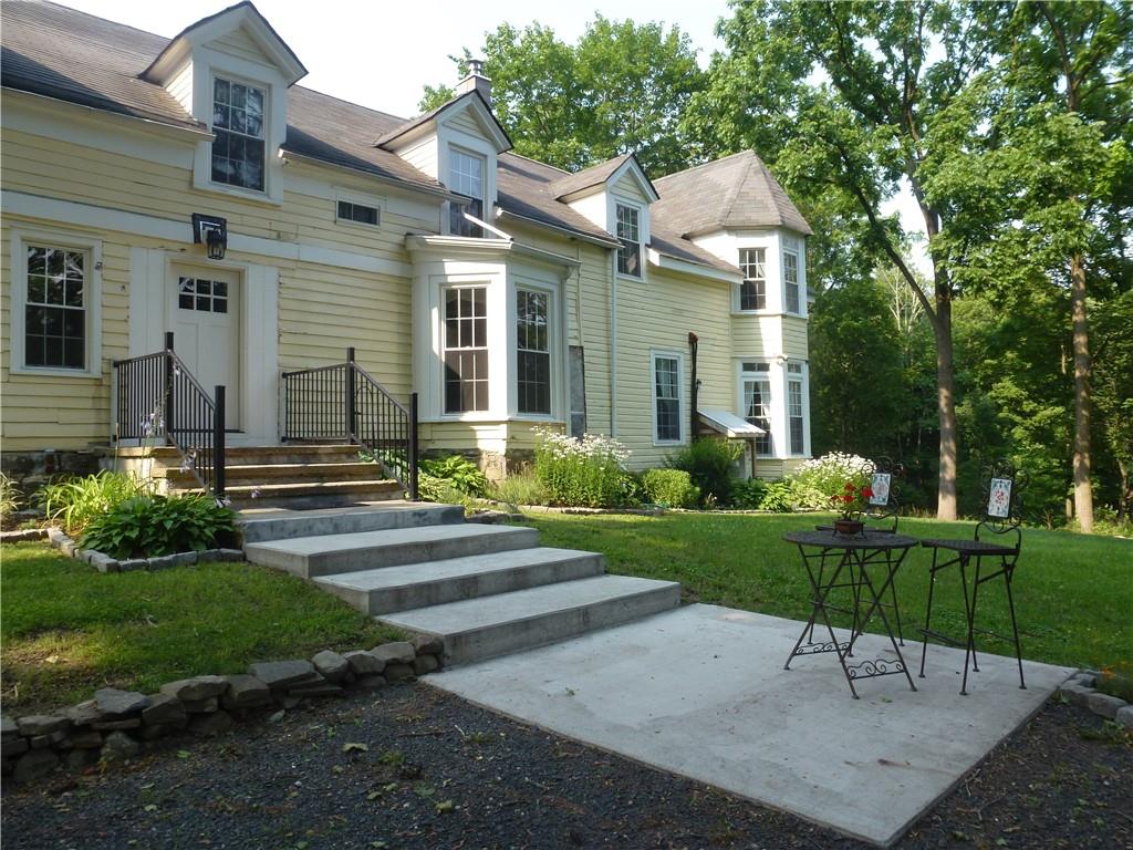 a front view of a house with garden and porch