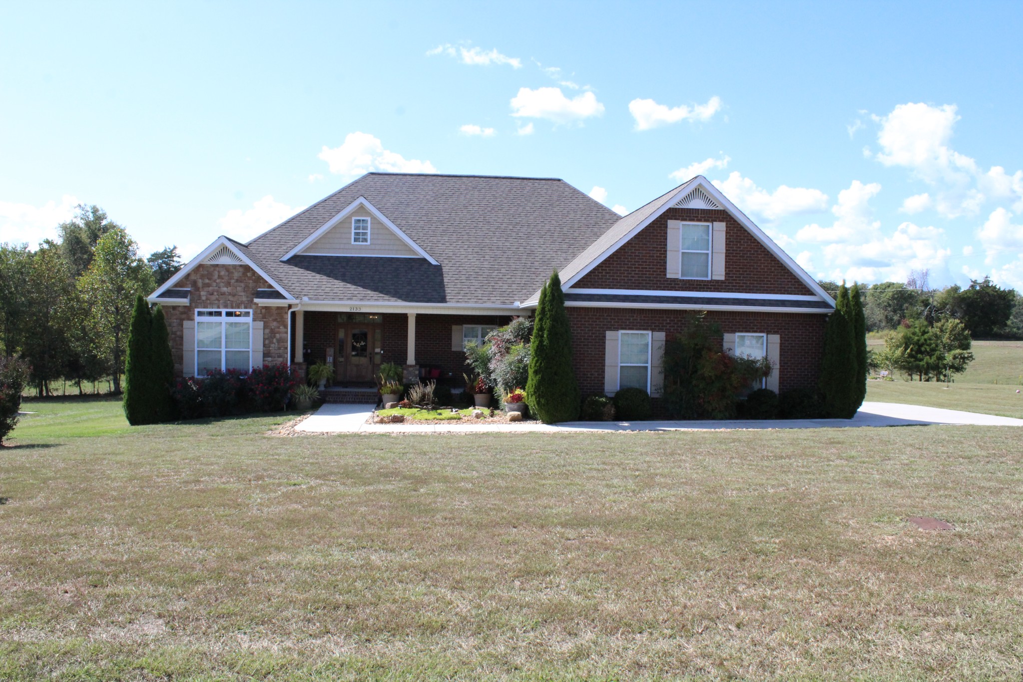 a front view of a house with a yard and garage