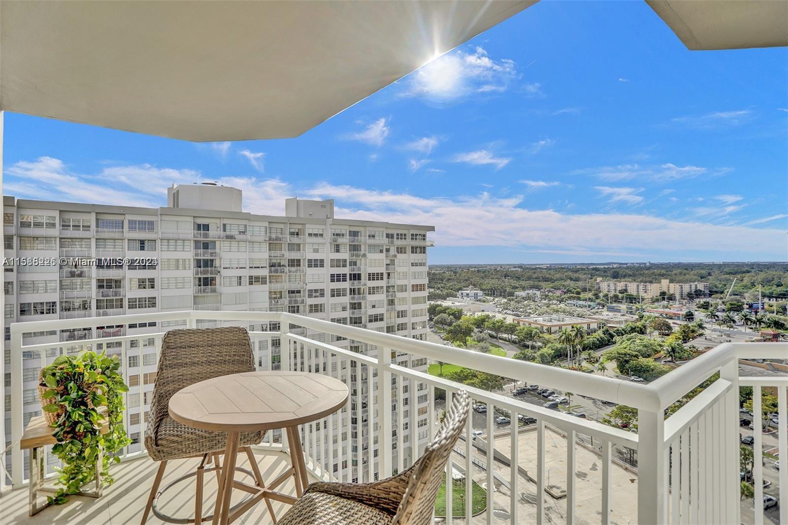 a view of a balcony with an outdoor seating