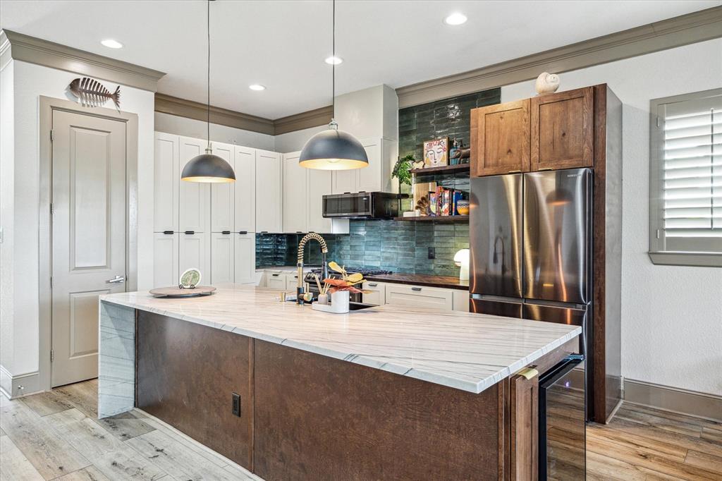 a kitchen with refrigerator and cabinets