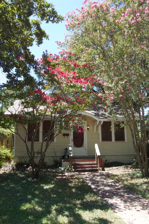 a view of a house with a tree