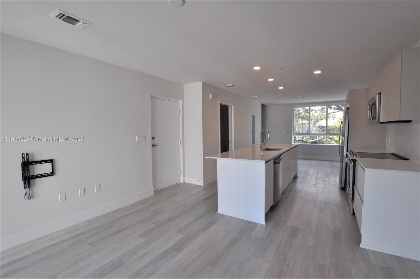 a view of kitchen with cabinets and wooden floor