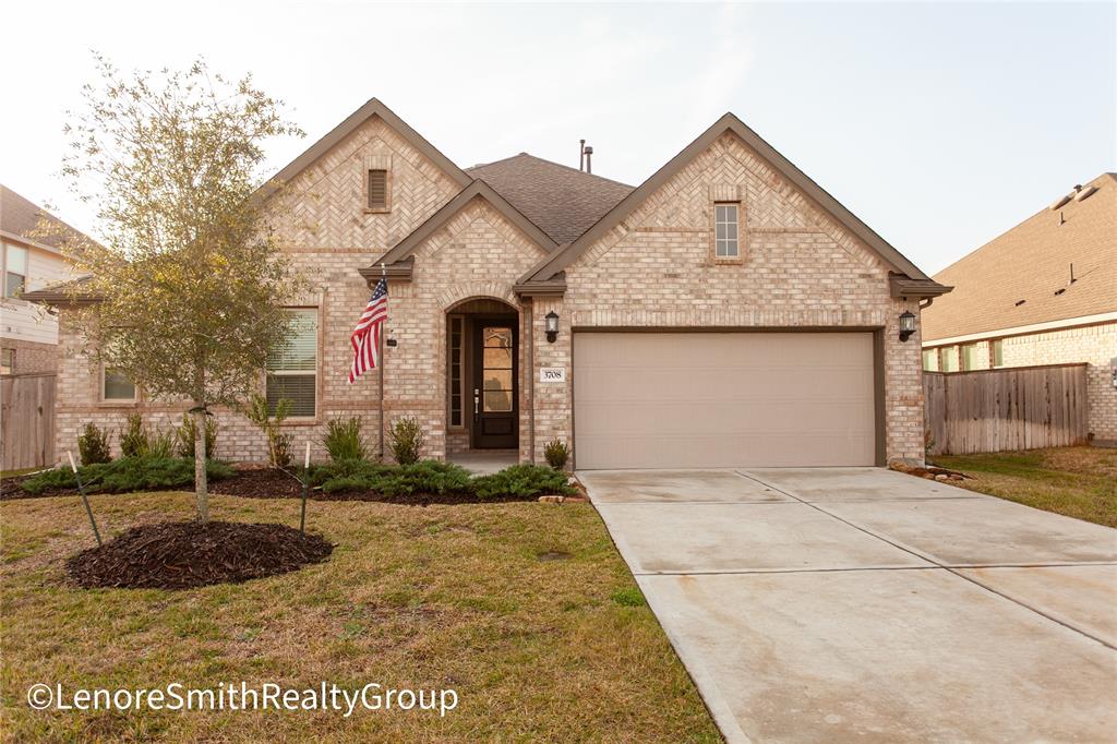 Charming Lennar single-story brick home with a gabled roof and a two-car garage. The house features a welcoming front entry and well-maintained landscaping