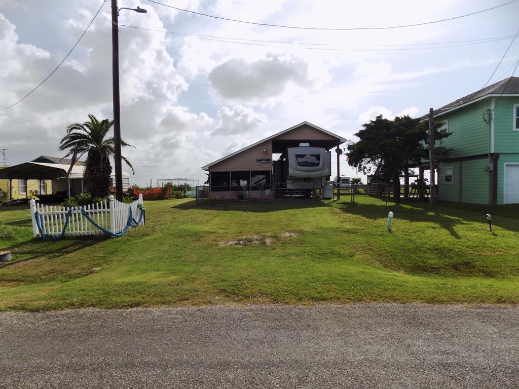 a view of a house with a big yard and potted plants