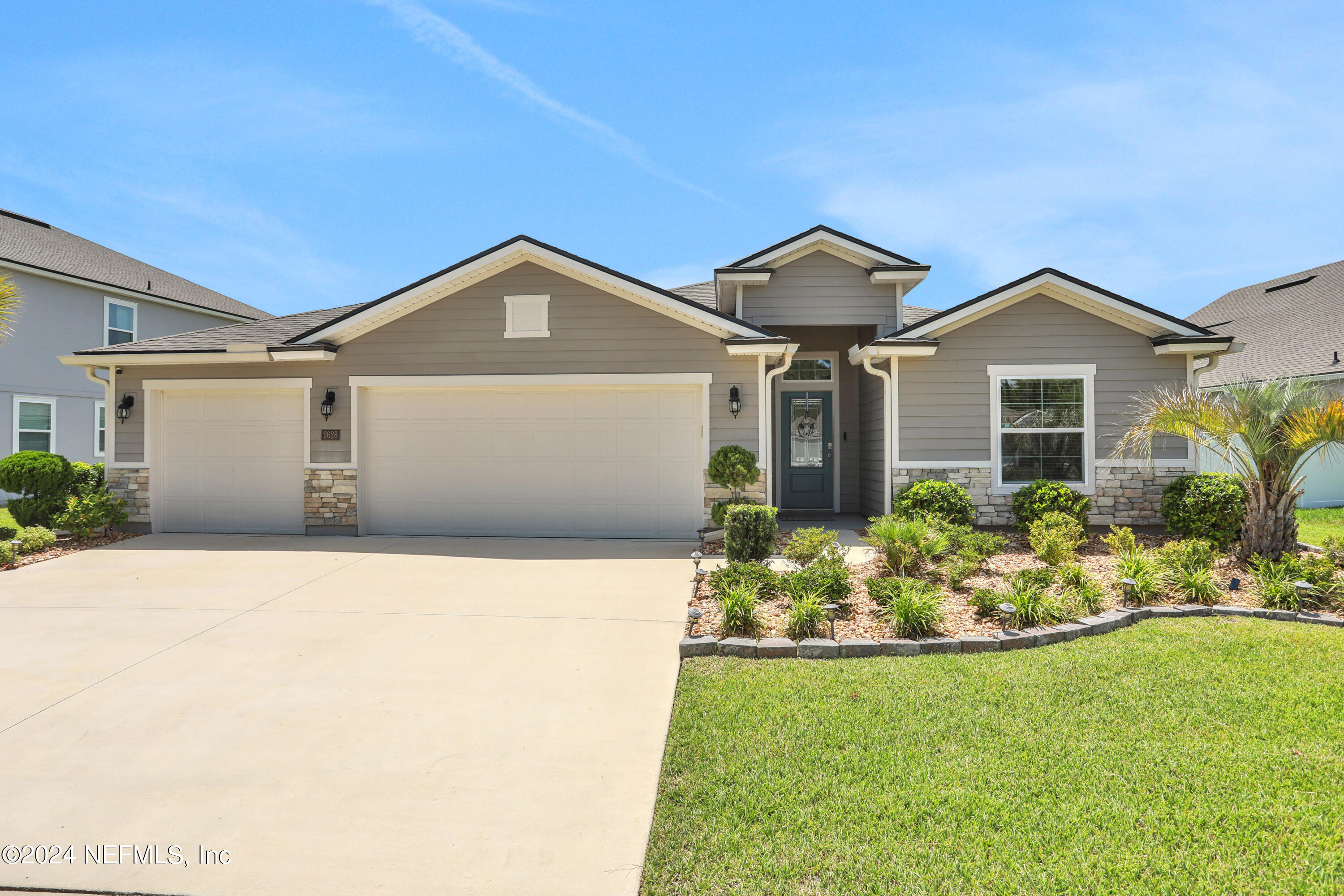 a front view of a house with a yard and garage