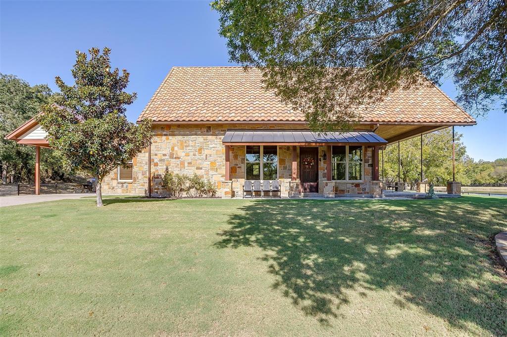 a front view of a house with a garden