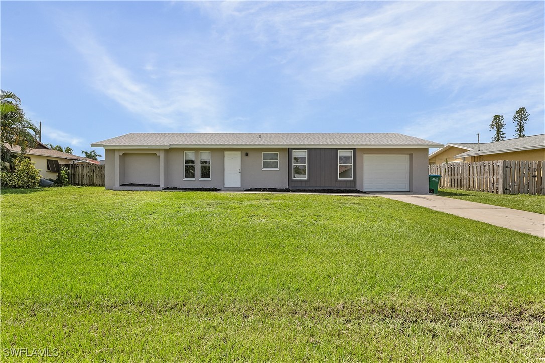 a view of house with yard and green space