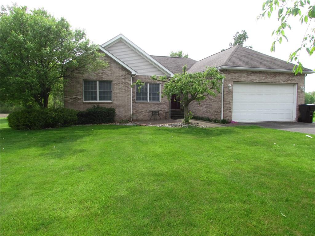 a front view of a house with a garden and yard