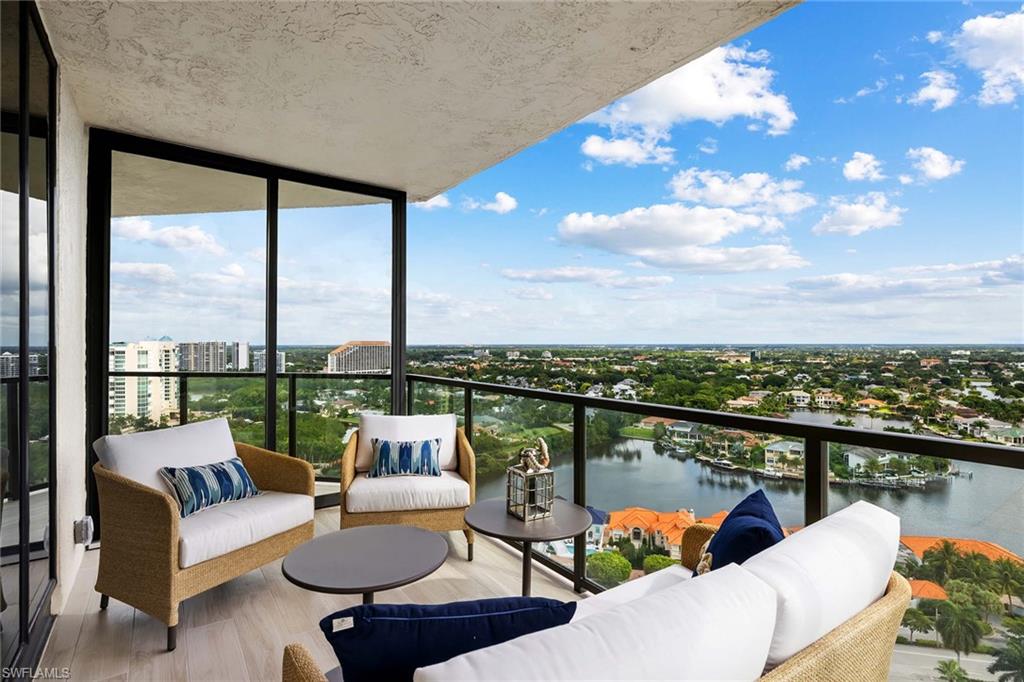 a balcony with furniture and a view of lake