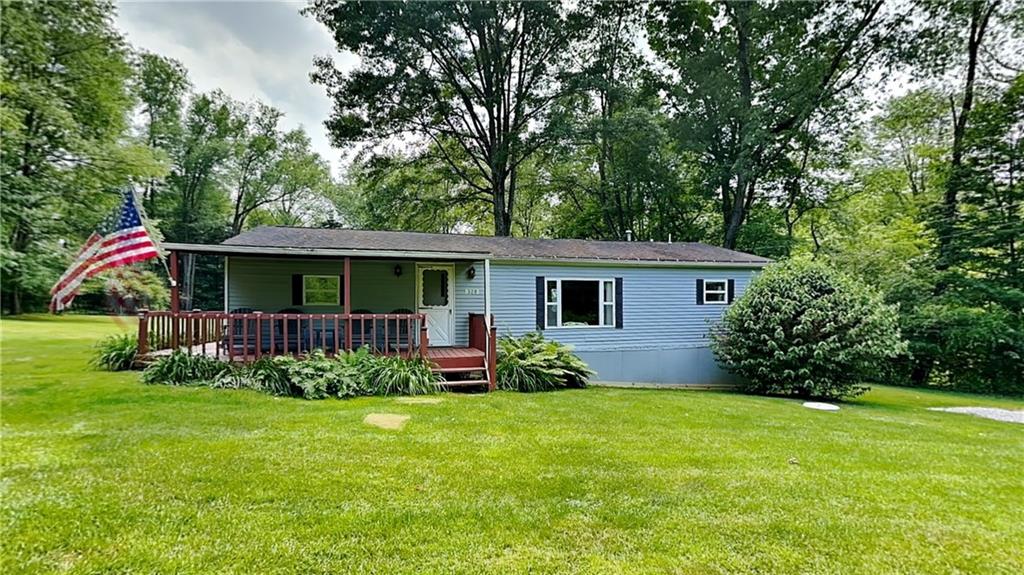 a view of house with backyard and garden