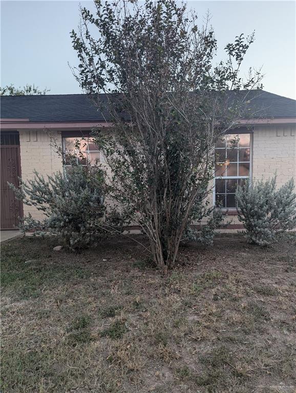 View of side of property with a yard