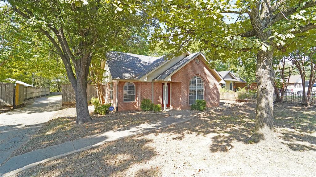 a front view of a house with a yard and tree s