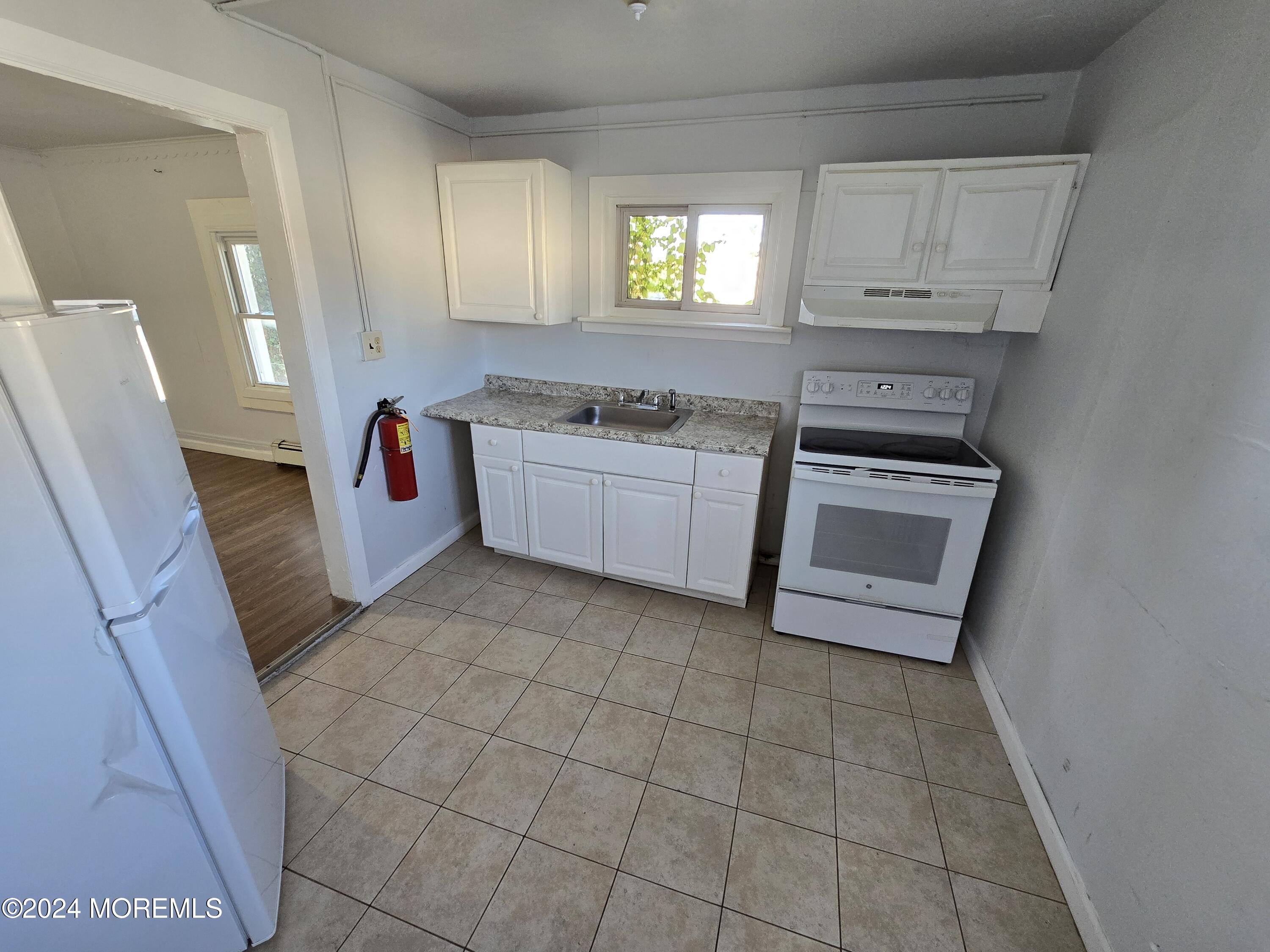 a kitchen with a stove a sink and a microwave